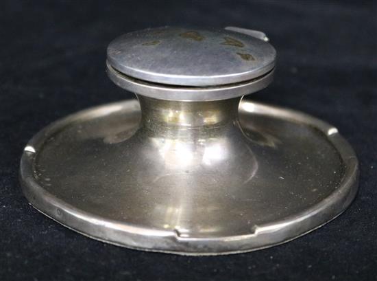 A silver capstan inkwell.